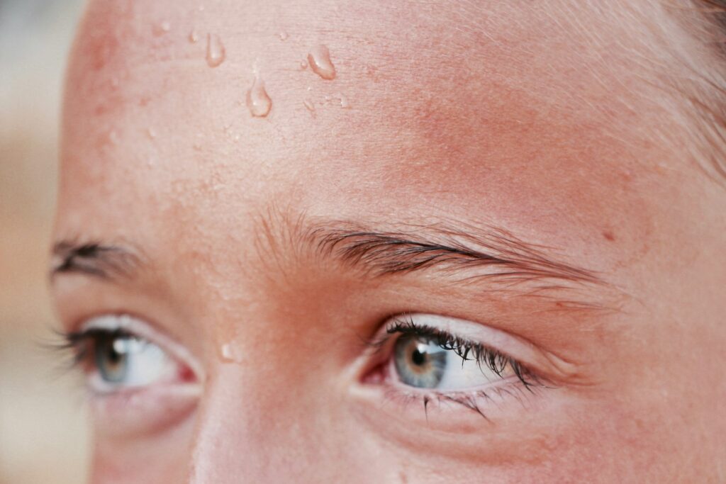 Close-up of a sweaty face showing physical symptoms of anxiety in hot weather