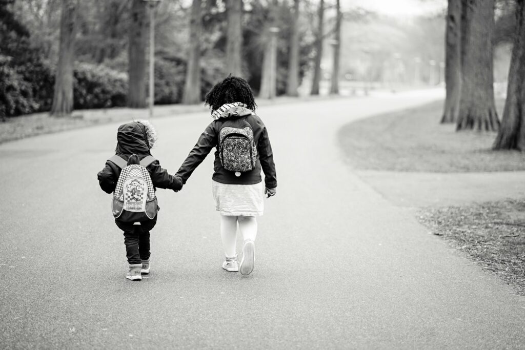 Children walking to school alone, representing back-to-school anxiety for parents