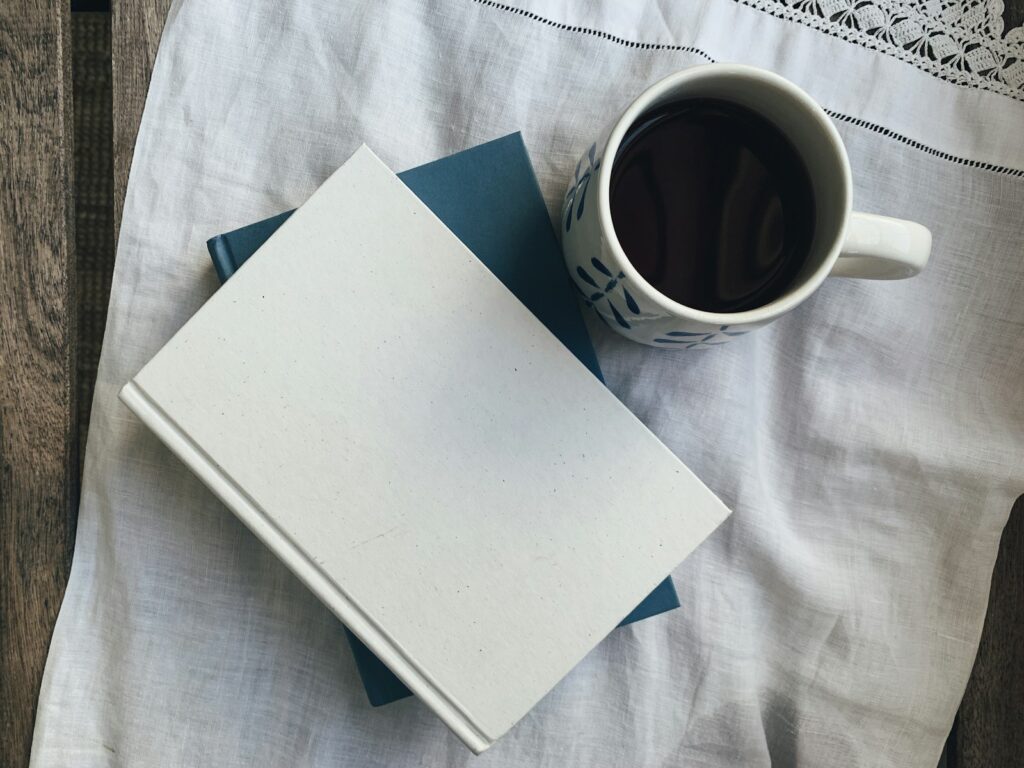 Notebook and coffee representing a gentle approach to New Year's resolutions.