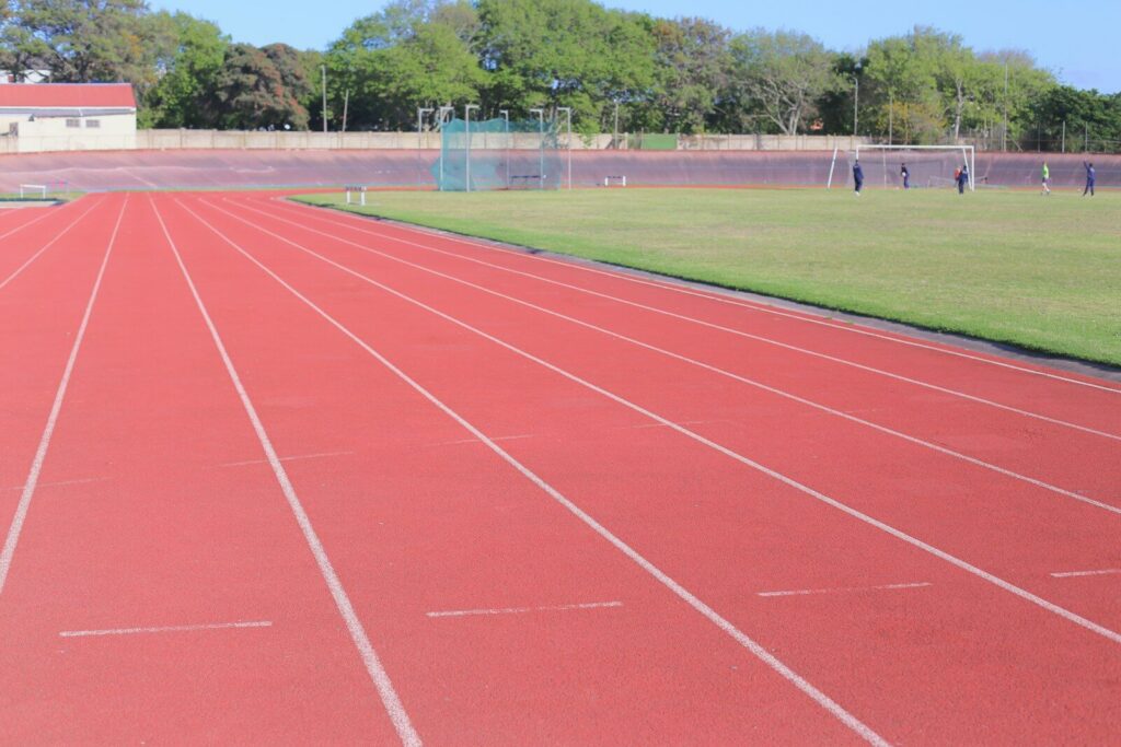 Empty outdoor track field symbolizing focus, training, and pressure in athletes.