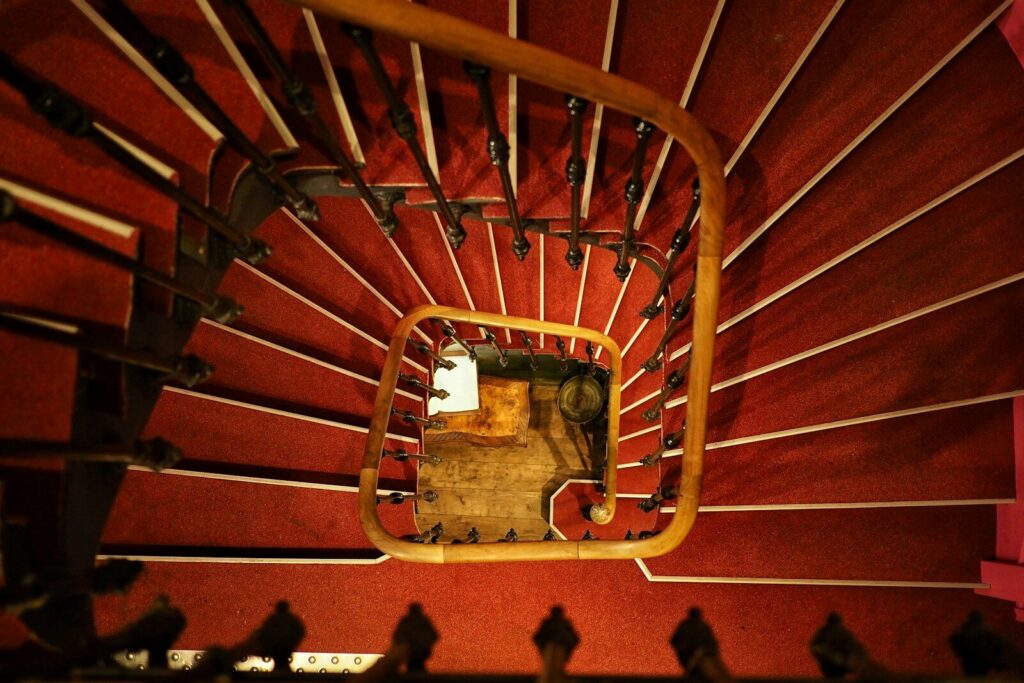 Top-down view of a spiraling staircase symbolizing repetitive thought patterns and the mental loop of Relationship OCD.